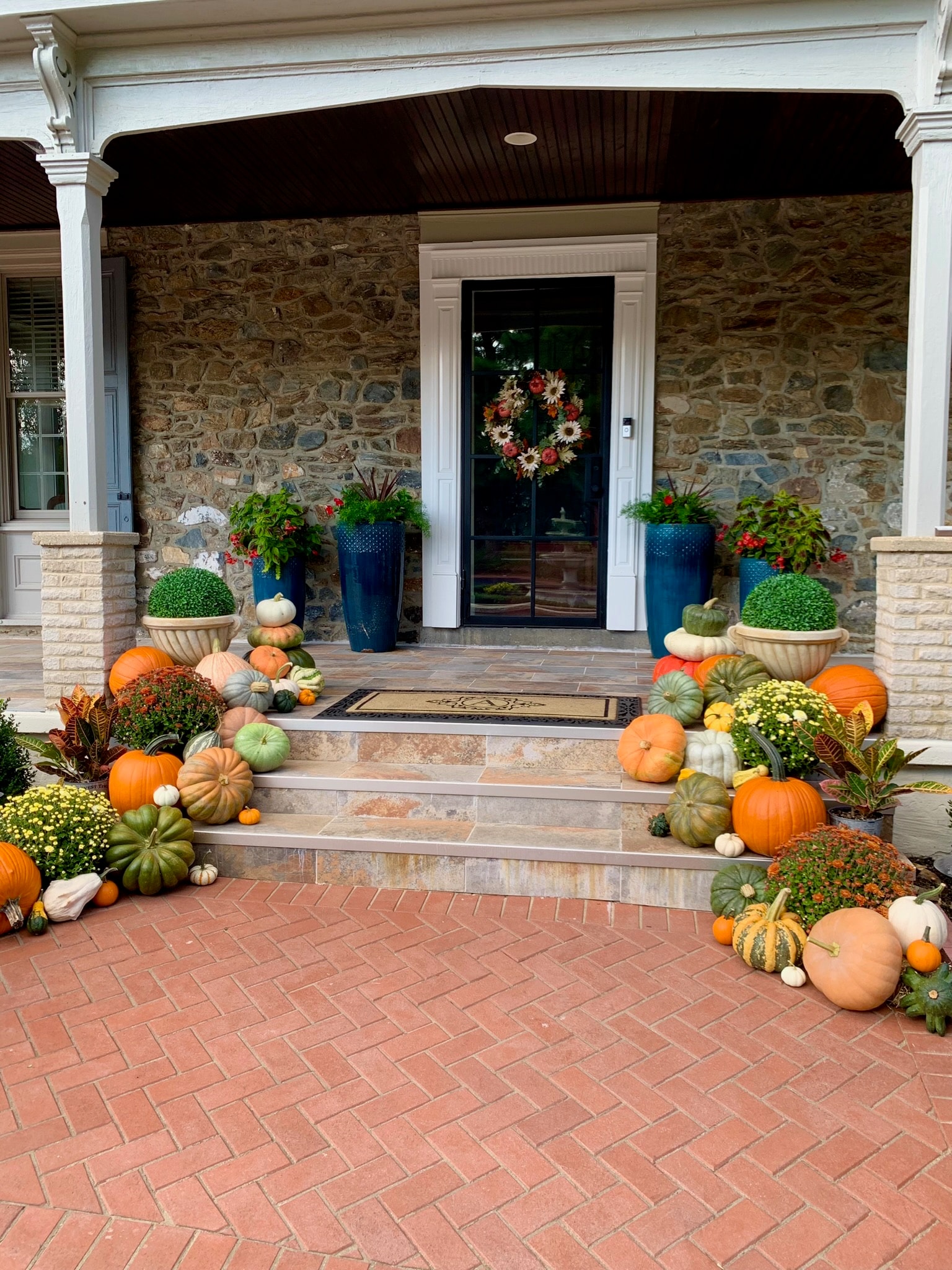 Brick porch with pumpkin steps display